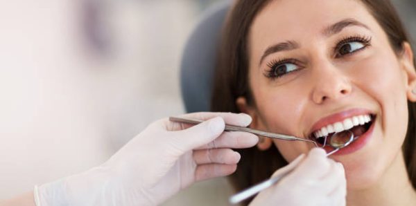 Woman having teeth examined at dentists